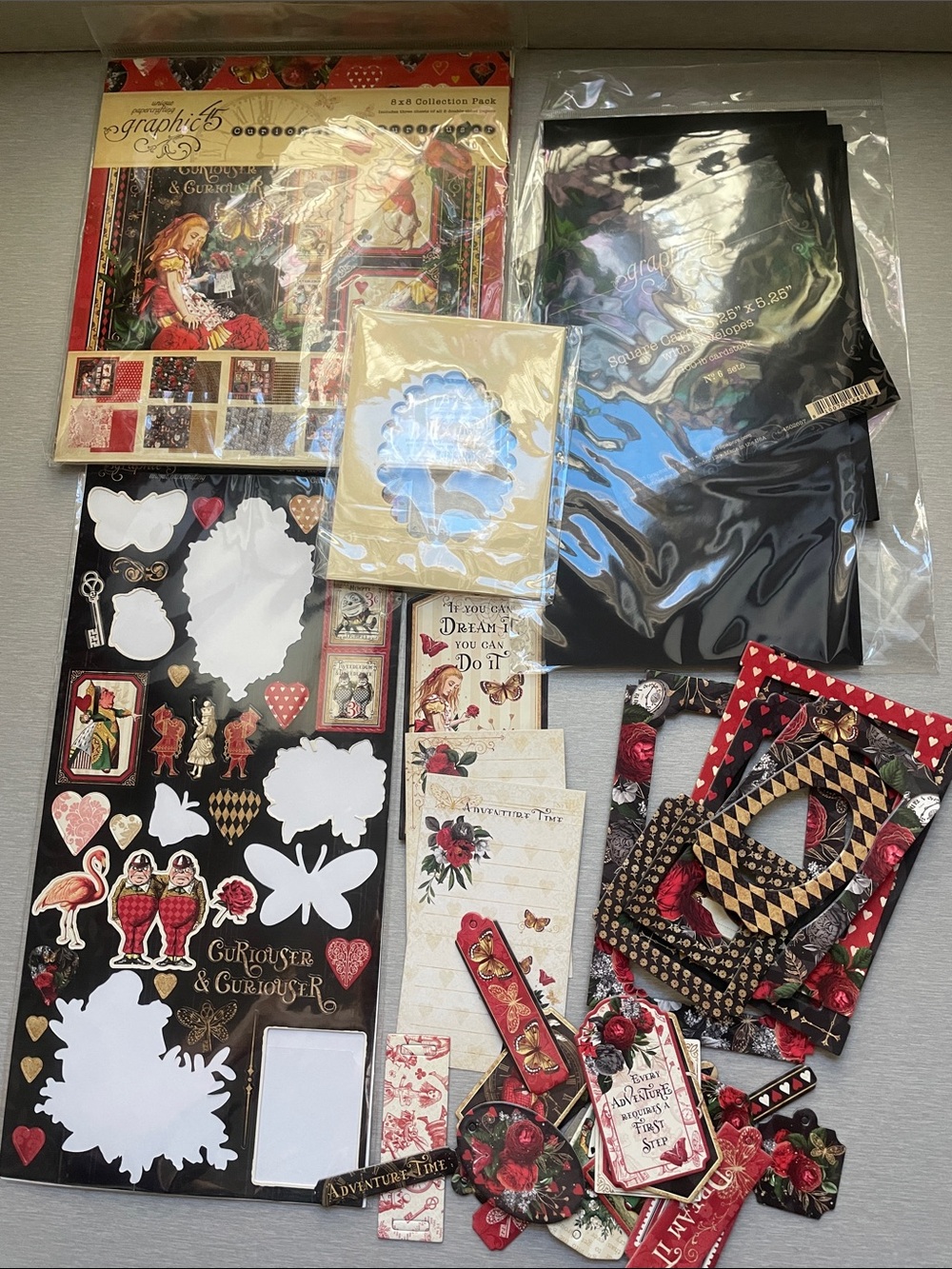 Graphic 45 Curiosities & Curioser Craft Paper and Die-Cut Embellishments Read